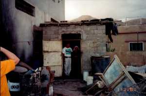Bob & Kodra in Kodra's doorway. The small space is her home.
